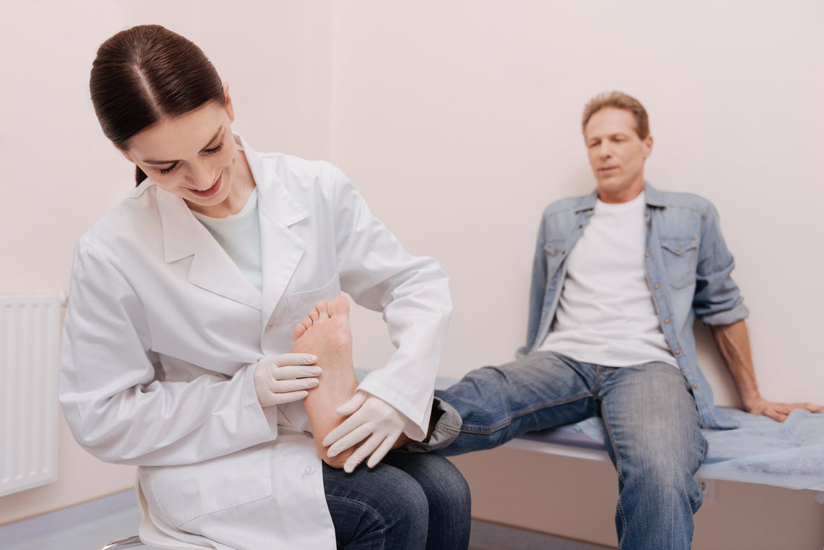 Doctor checking feet Foot & Leg Centre