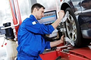 Mechanic checking wheel alignment