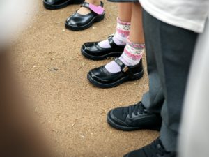 Children in school shoes stanging in a line