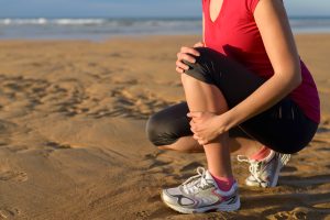 Runner holding sore shin